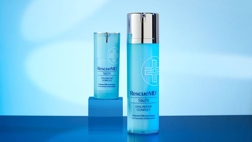 photo of two bottles of rescuemd skin dna repair complex on blue background